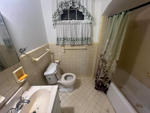 full bathroom with tile walls, shower / bathtub combination with curtain, vanity, tile patterned flooring, and toilet