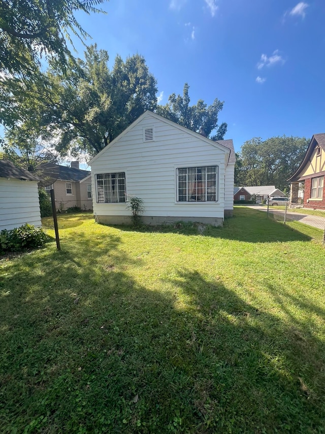 rear view of house featuring a yard