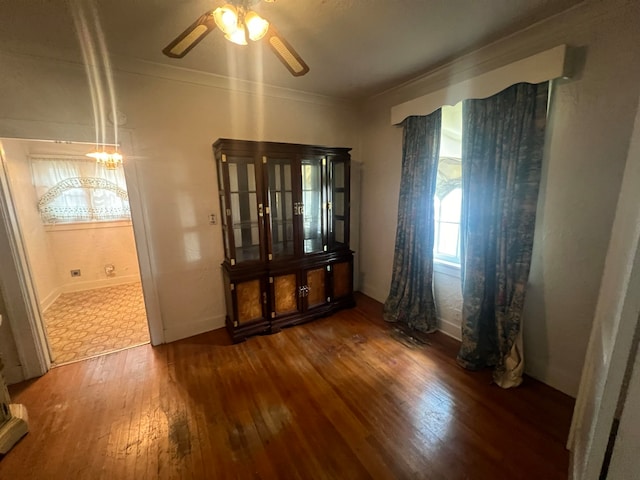 spare room featuring ceiling fan, crown molding, and dark hardwood / wood-style flooring