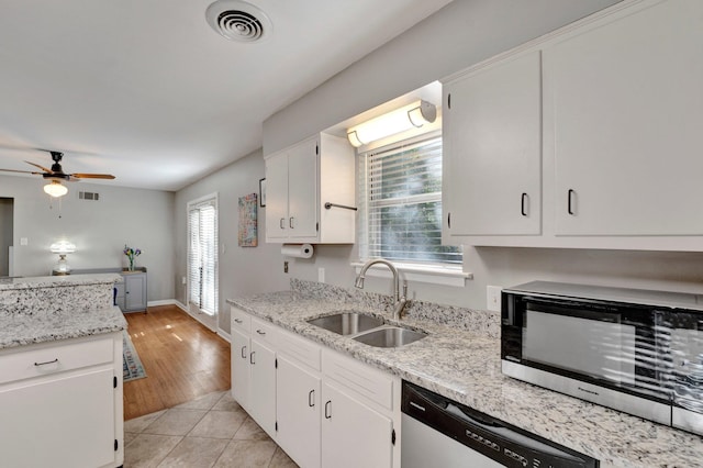 kitchen with white cabinets, appliances with stainless steel finishes, sink, and a wealth of natural light