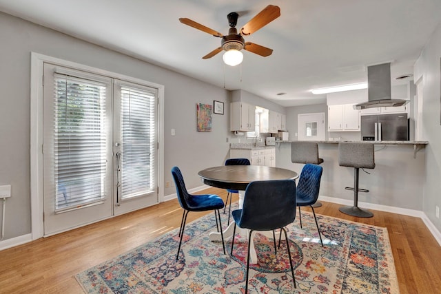 dining area featuring ceiling fan and light hardwood / wood-style flooring