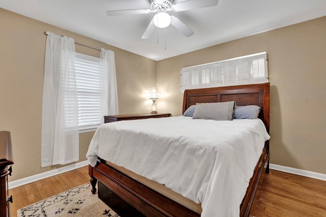 bedroom with ceiling fan and light wood-type flooring