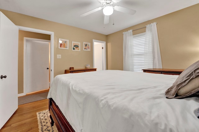 bedroom with light hardwood / wood-style flooring and ceiling fan