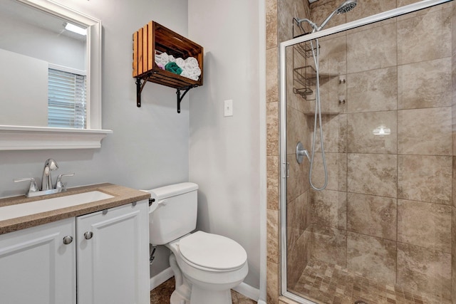 bathroom with a shower with door, toilet, and vanity