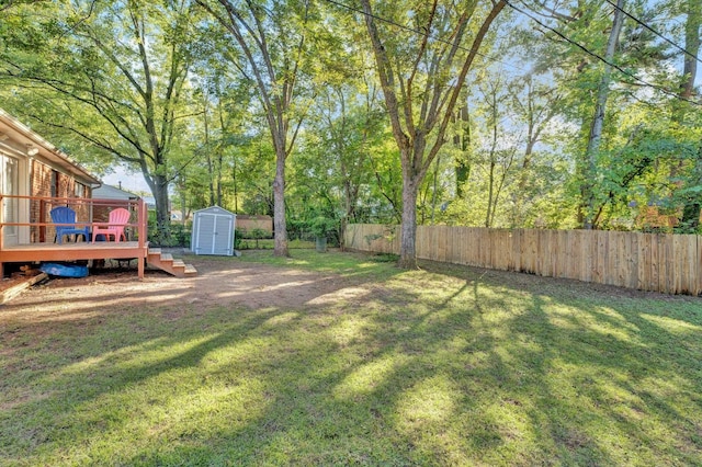 view of yard with a storage shed and a wooden deck