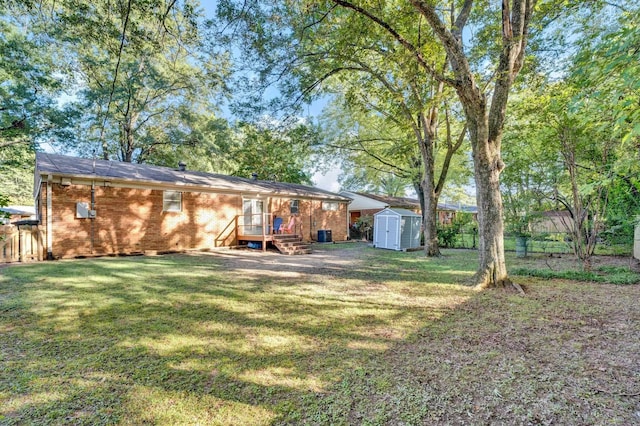 rear view of house featuring a lawn and a shed