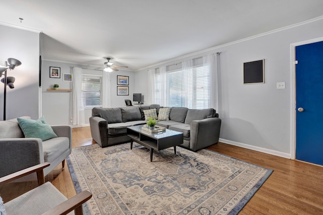 living room featuring ornamental molding, hardwood / wood-style floors, ceiling fan, and plenty of natural light