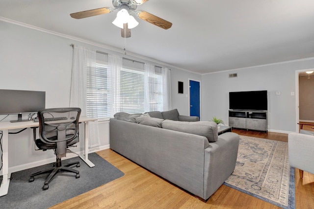 living room featuring ceiling fan, light hardwood / wood-style flooring, and ornamental molding