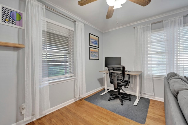 office space with ornamental molding, hardwood / wood-style floors, ceiling fan, and a healthy amount of sunlight