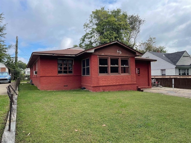 back of property featuring a yard