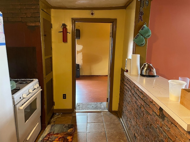 kitchen featuring dark tile patterned flooring and white stove