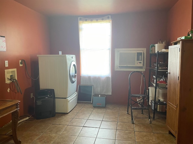 washroom featuring an AC wall unit, light tile patterned floors, and washer / dryer