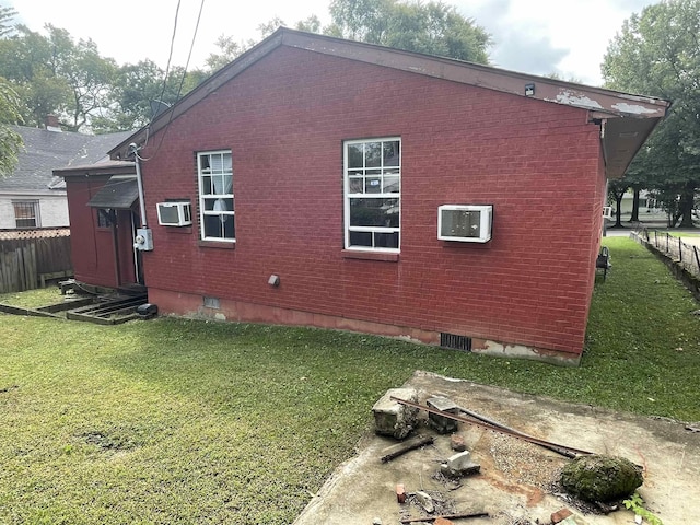 view of home's exterior with a lawn and a wall unit AC