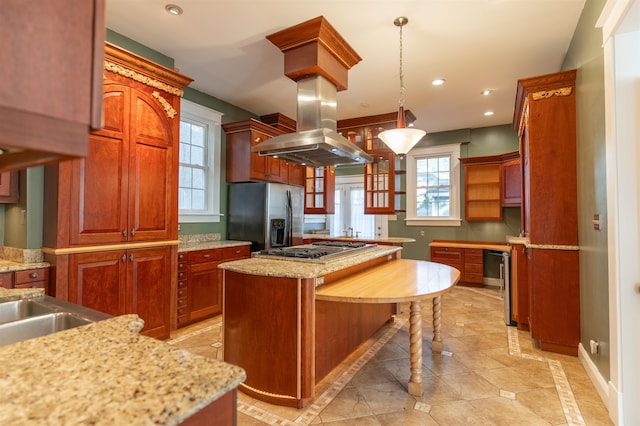 kitchen featuring decorative light fixtures, island exhaust hood, stainless steel appliances, and a healthy amount of sunlight