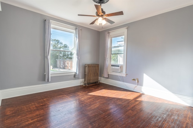 spare room with ceiling fan, radiator, plenty of natural light, and dark hardwood / wood-style floors