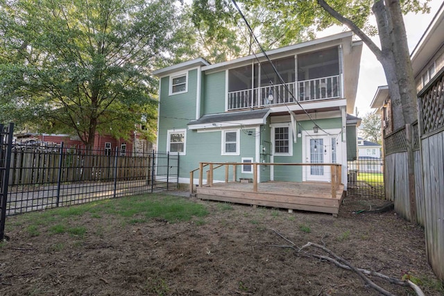 back of property featuring a sunroom and a deck