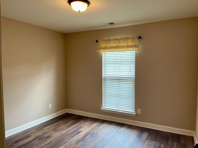 empty room featuring dark hardwood / wood-style floors