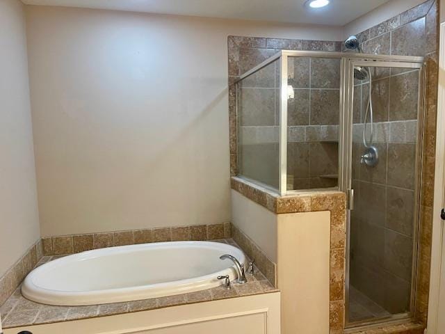 bathroom featuring separate shower and tub