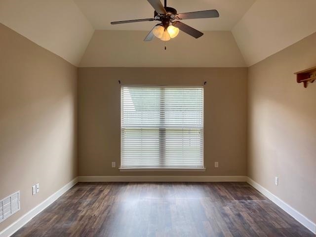 spare room with lofted ceiling, ceiling fan, and dark hardwood / wood-style flooring