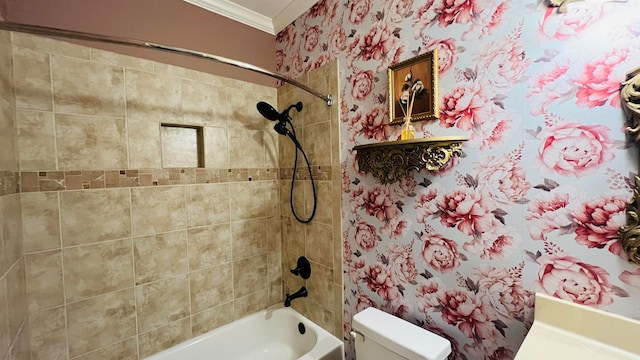 bathroom featuring toilet, ornamental molding, and tiled shower / bath