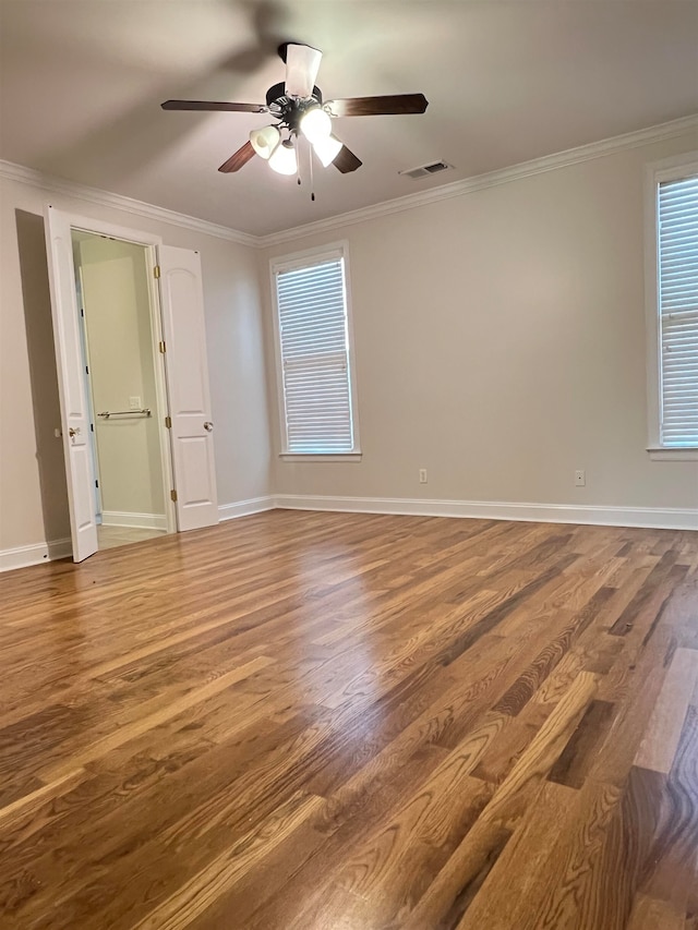 unfurnished room with hardwood / wood-style flooring, ceiling fan, and ornamental molding