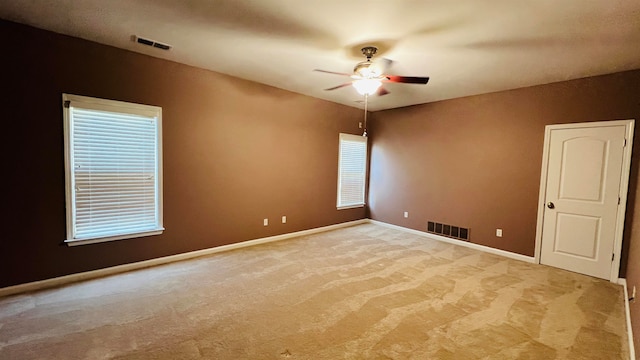 empty room featuring light carpet and ceiling fan