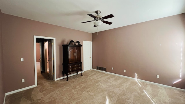 unfurnished bedroom with ceiling fan and carpet