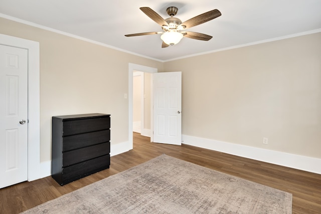 unfurnished bedroom with ornamental molding, ceiling fan, and hardwood / wood-style floors