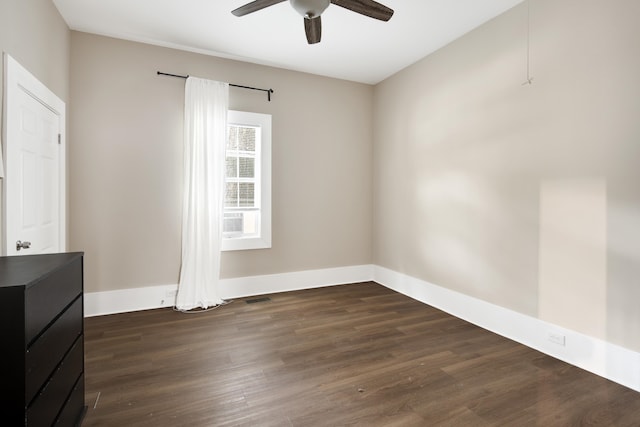 empty room featuring dark hardwood / wood-style floors and ceiling fan