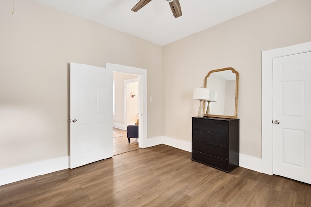 unfurnished bedroom featuring ceiling fan and hardwood / wood-style flooring