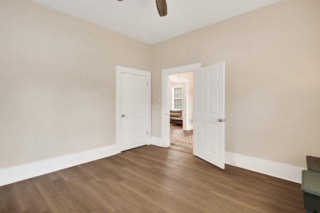 spare room featuring dark hardwood / wood-style flooring and ceiling fan