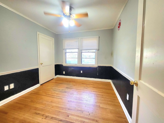 empty room featuring ceiling fan, light hardwood / wood-style flooring, and crown molding