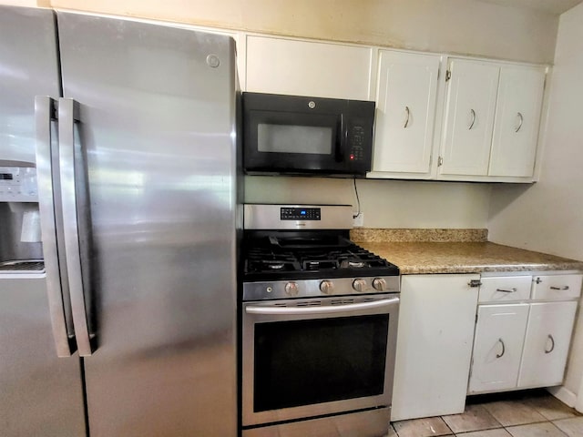 kitchen featuring appliances with stainless steel finishes, white cabinetry, and light tile patterned floors