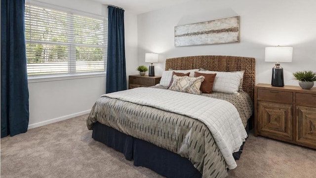 bedroom featuring carpet and baseboards