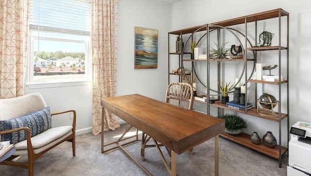 carpeted home office featuring baseboards