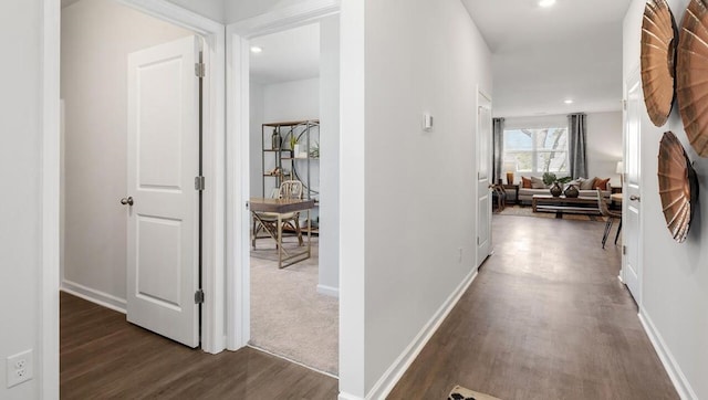 hallway with dark wood-style floors, baseboards, and recessed lighting