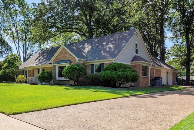 view of front of house featuring a front lawn and central AC