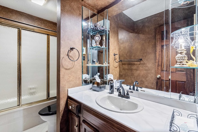 full bathroom featuring tile patterned flooring, shower / bath combination with glass door, toilet, and vanity