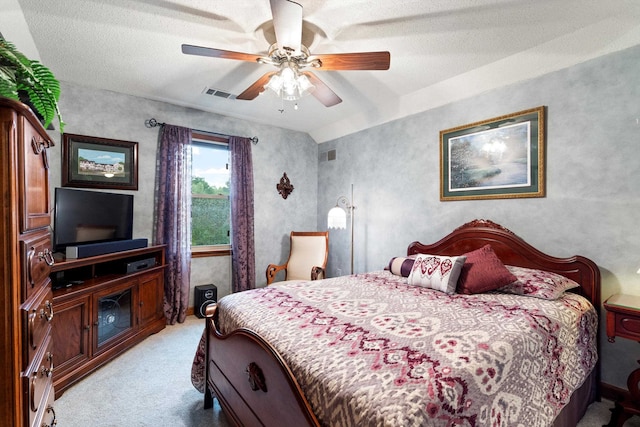 carpeted bedroom with a textured ceiling and ceiling fan