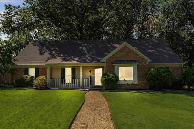 ranch-style house with a porch and a front yard