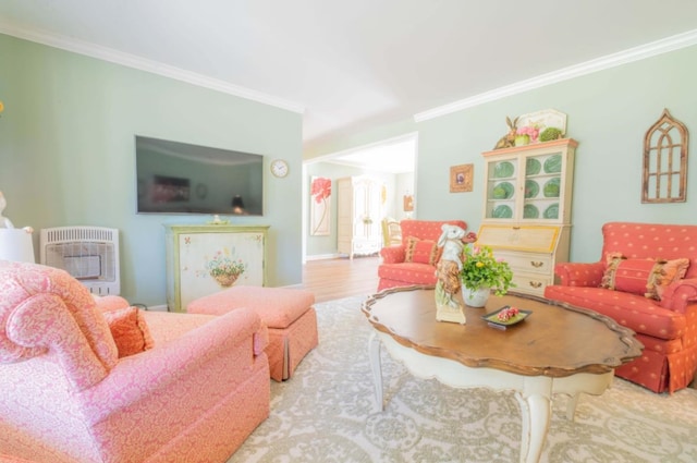 living room with ornamental molding, heating unit, and hardwood / wood-style flooring