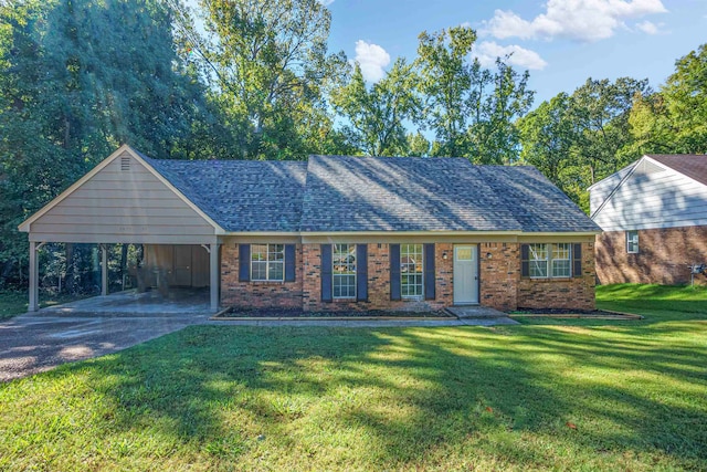 view of front of home with a front yard and a carport