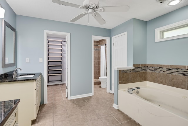 bathroom with a bathtub, vanity, ceiling fan, toilet, and tile patterned floors