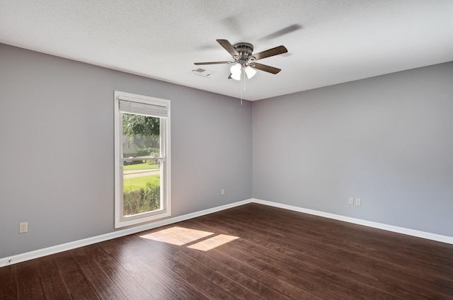 spare room featuring ceiling fan, a textured ceiling, and dark hardwood / wood-style floors