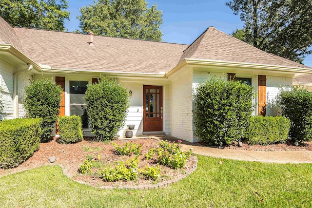 ranch-style home with a front lawn