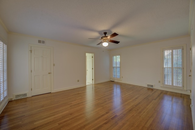 unfurnished room with ceiling fan, a textured ceiling, light wood-type flooring, and crown molding