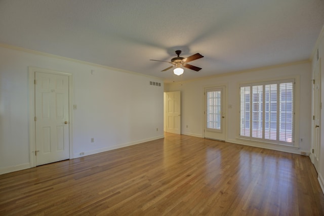 unfurnished room with ceiling fan, ornamental molding, a textured ceiling, and hardwood / wood-style floors