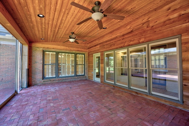 unfurnished sunroom featuring wood ceiling, vaulted ceiling, and ceiling fan