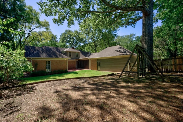 back of property featuring a lawn and a patio area