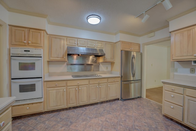 kitchen featuring white double oven, a textured ceiling, light brown cabinets, and stainless steel refrigerator